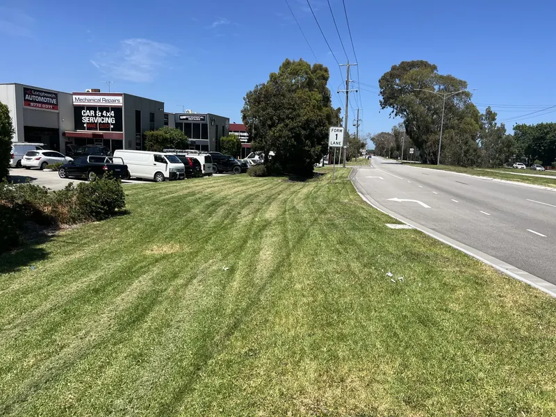 Mown grounds, edged paths and maintained garden beds at a commercial site in south-east Melbourne